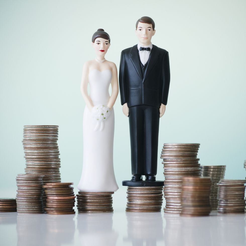 close-up-of-wedding-cake-figurines-on-stacks-of-royalty-free-image-129311402-1549637528